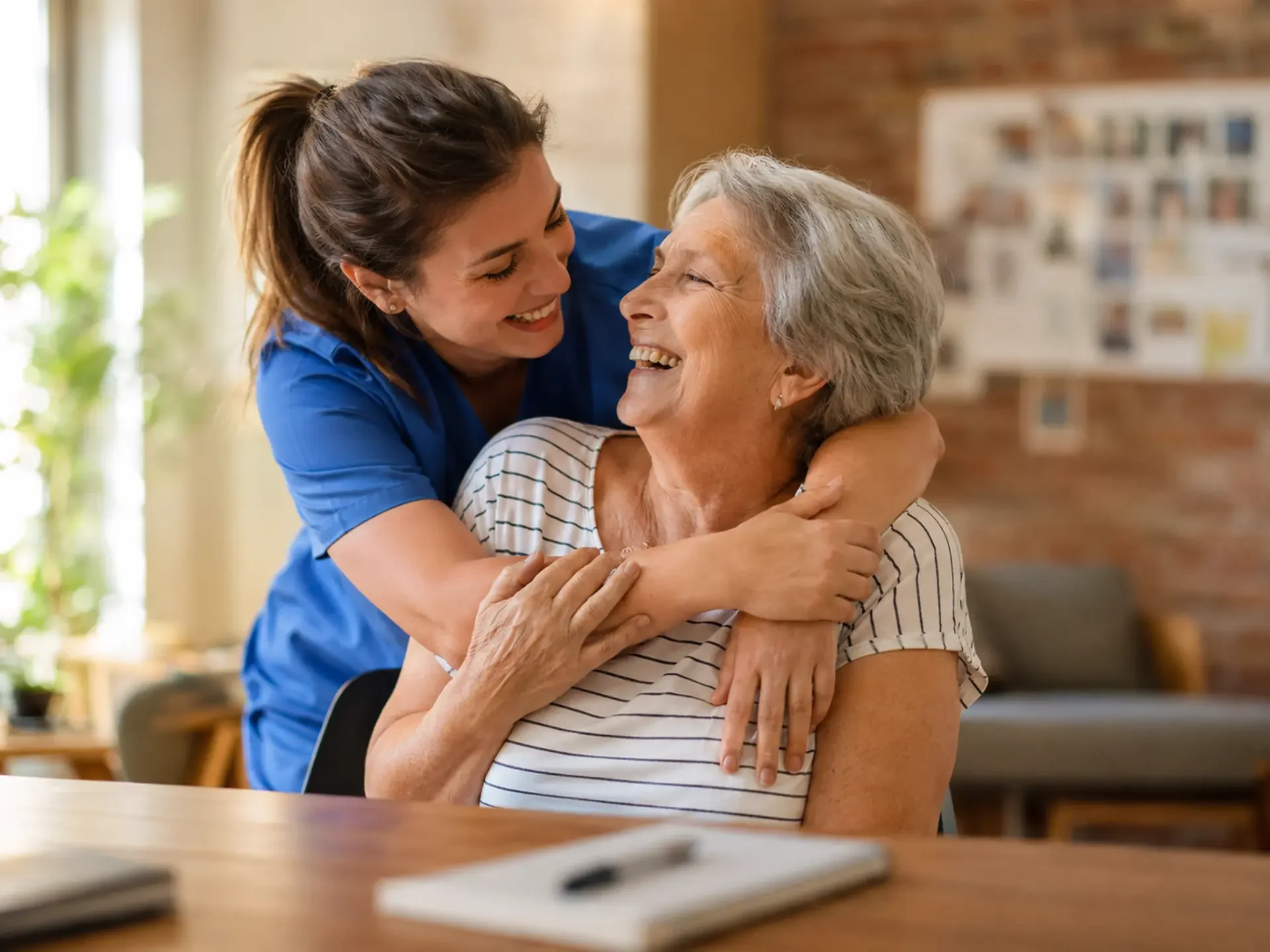 Caregiver sharing a warm moment with an older adult.
