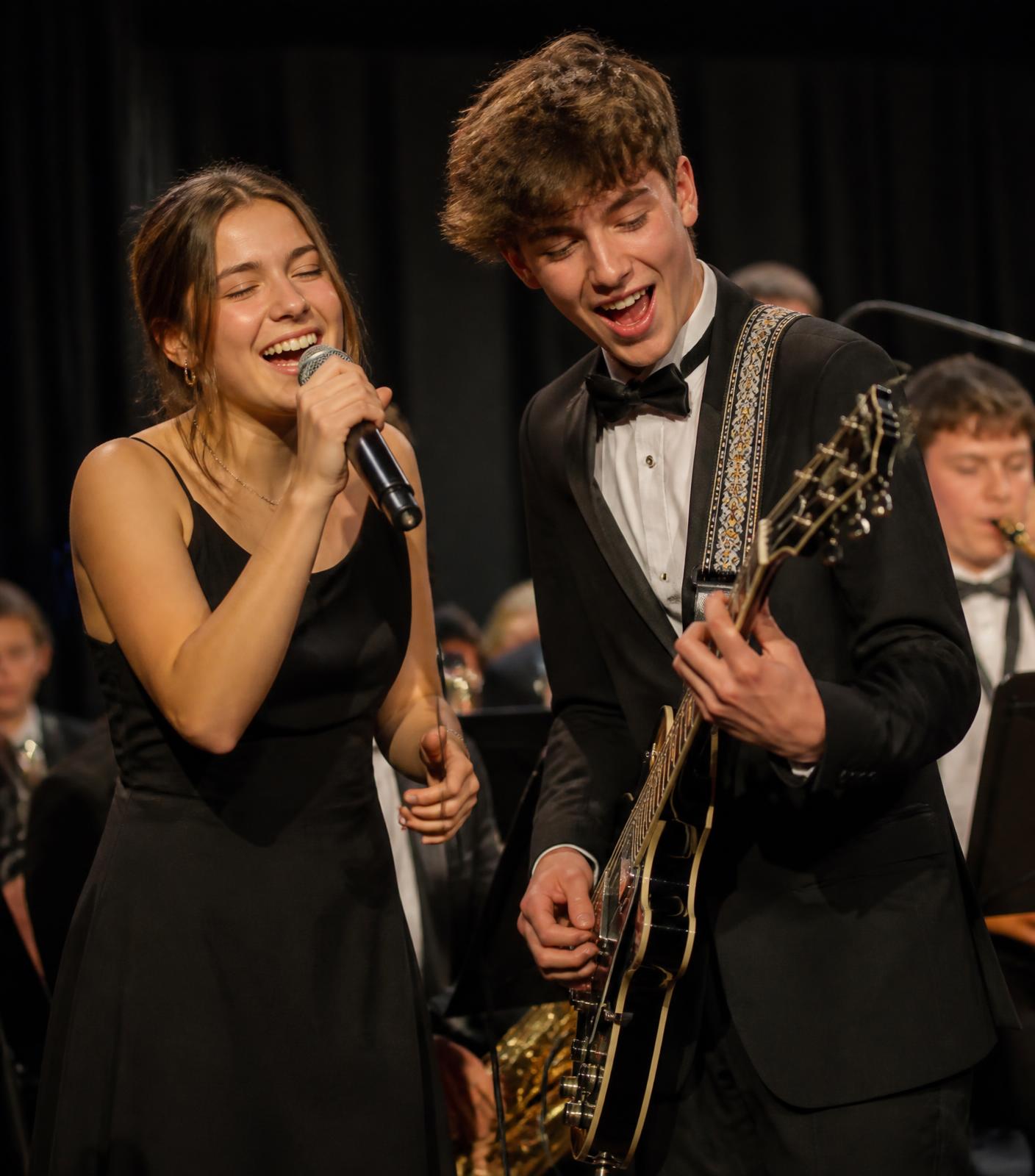 High school student musicians performing live for an engaged audience of older adults